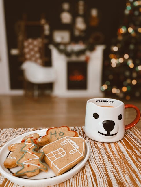 Festive holiday scene with decorated cookies and a hot drink in a cozy indoor setting.