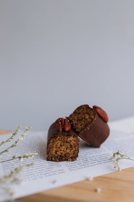 Delicious chocolate-covered pecan treats arranged on a styled background. Perfect for cozy winter indulgence.