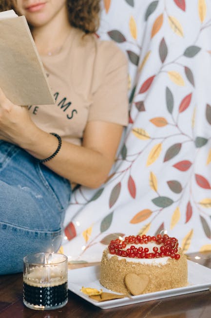 A woman enjoys a cozy autumn morning with a cake and coffee, embracing relaxation and warmth.